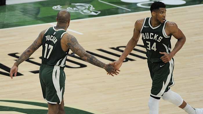 Milwaukee Bucks forward P.J. Tucker congratulates Milwaukee Bucks forward Giannis Antetokounmpo after scoring a basket